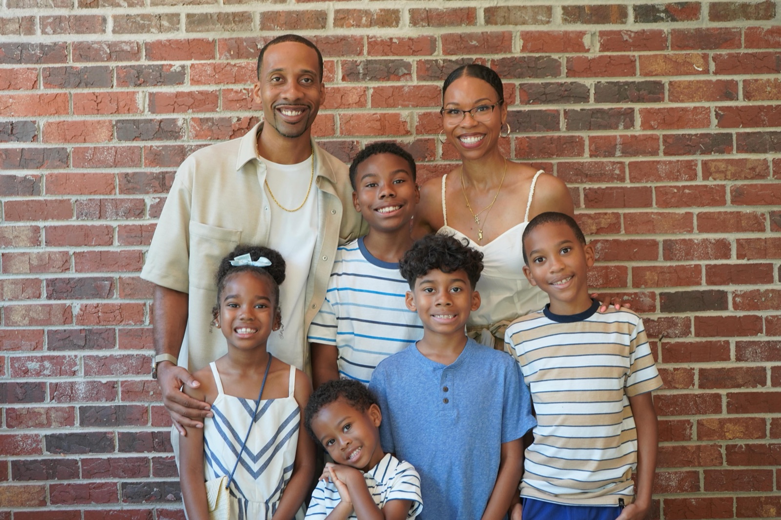 Brandon and Venessa Barnes with their five children, family-owned cash home buyers in Chamblee, GA