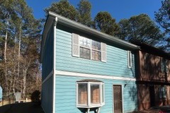 Blue townhome in Austell, GA that Mighty Estates bought with the tenant in place
