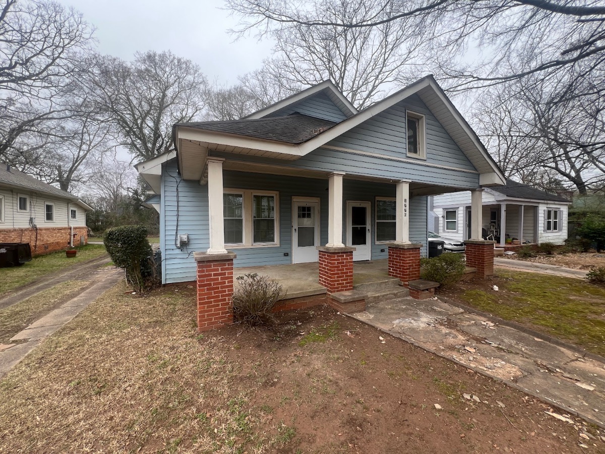 Blue bungalow duplex on Thompson Ave in East Point, GA as Mighty Estates bought it
