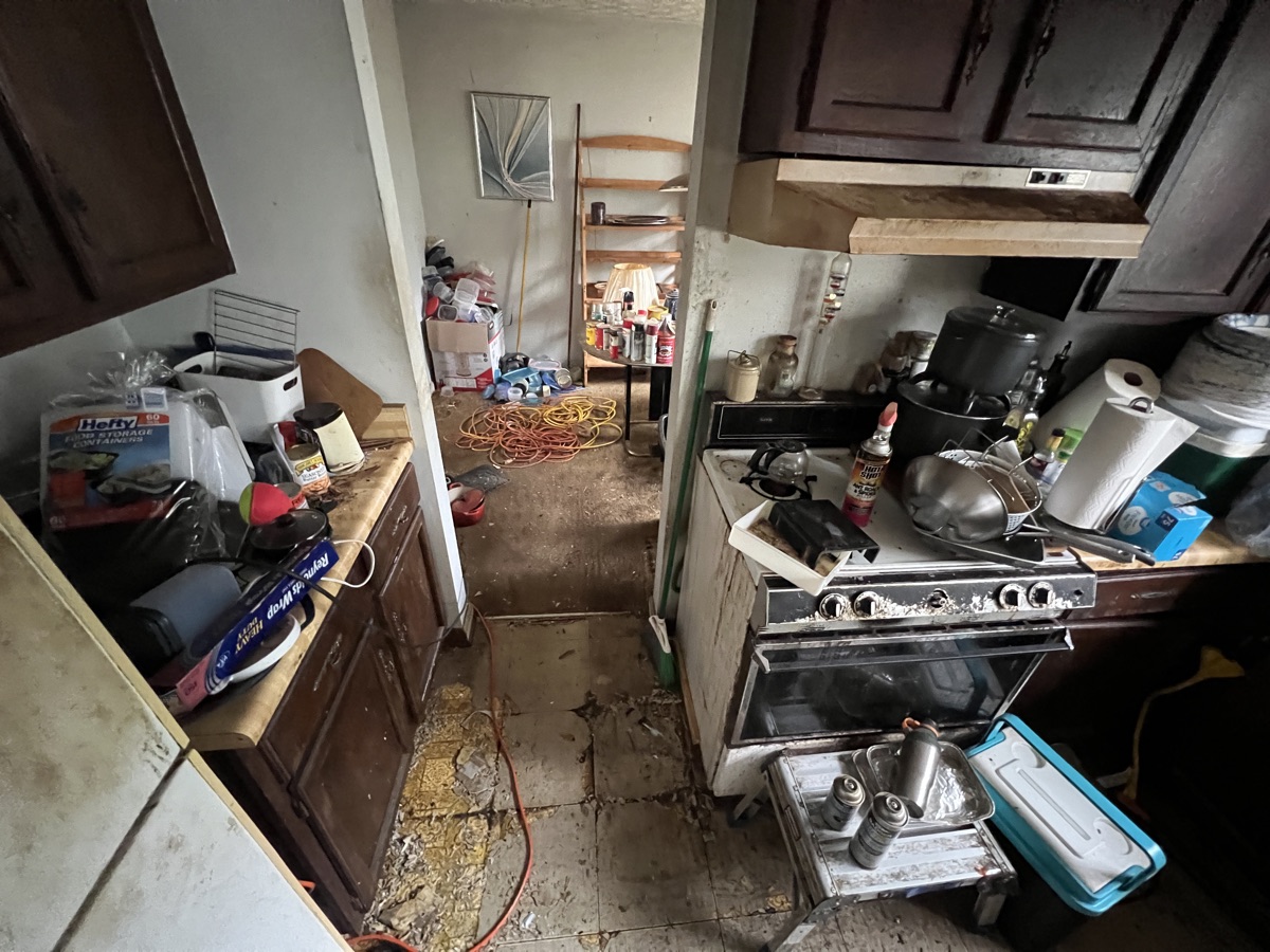 Cluttered, outdated kitchen in a Stone Mountain, GA house before Mighty Estates bought it as-is