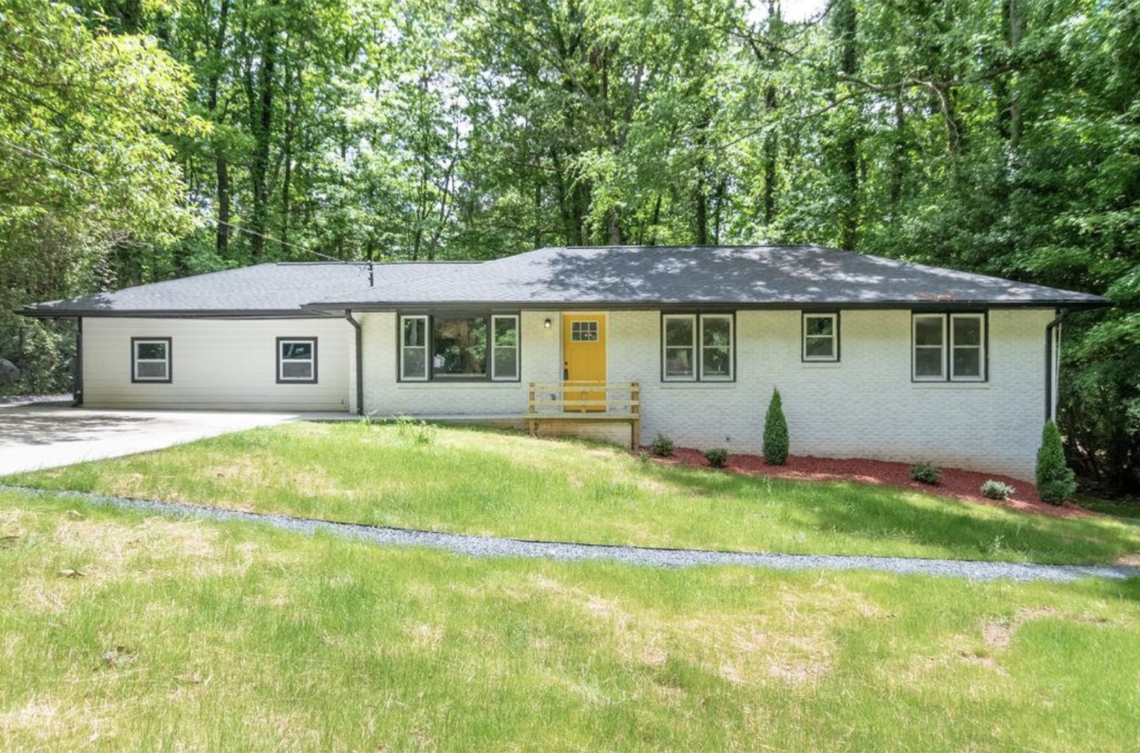 Same Metro Atlanta house after full renovation by Mighty Estates, new roof, paint, and landscaping